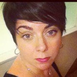 Profile picture of a white woman with short dark hair.