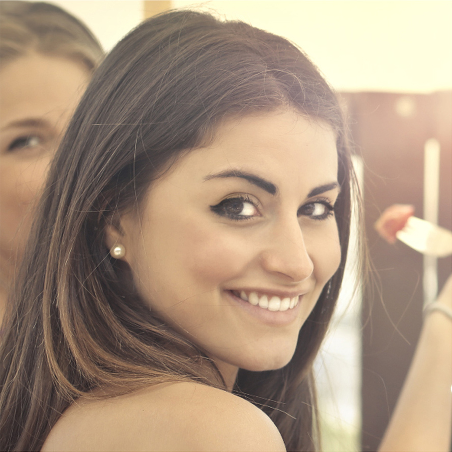 A profile picture of a beautiful woman in her early 20s with brown hair and brown eyes.